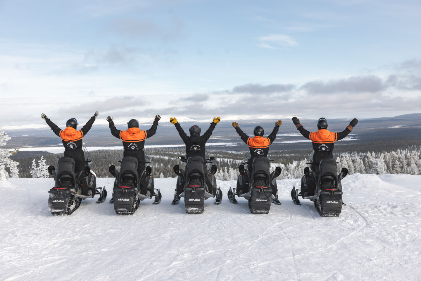 Snowmobiling adventure in a snowy Arctic landscape in Finnish Lapland
