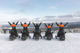 Snowmobiling adventure in a snowy Arctic landscape in Finnish Lapland