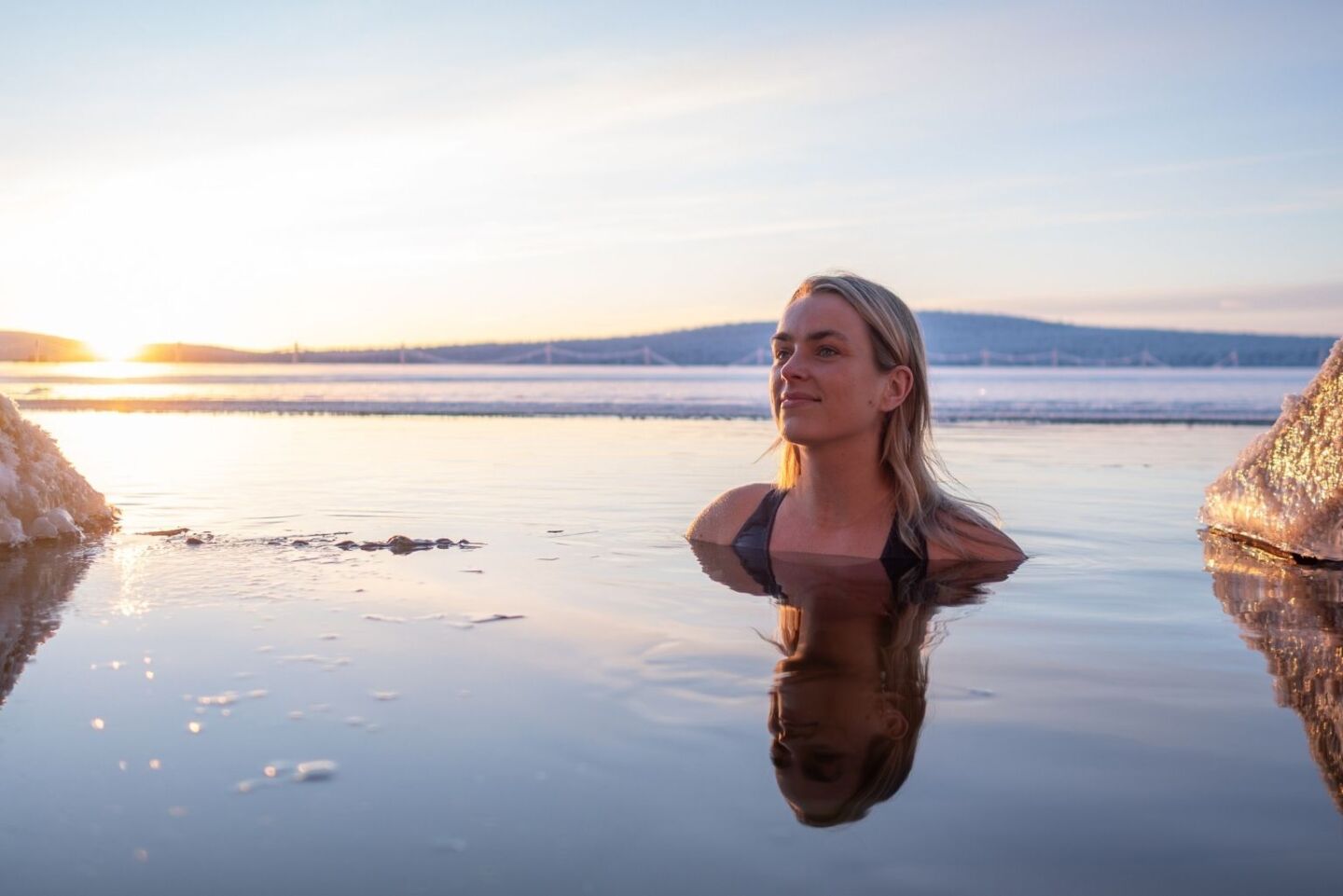 Outdoor bathing experience in the snowy Arctic landscape at Arcora Spa and Wellness