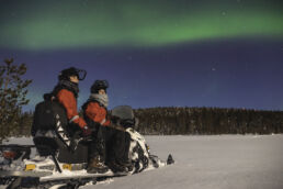 Guests watching the Northern Lights in Finnish Lapland